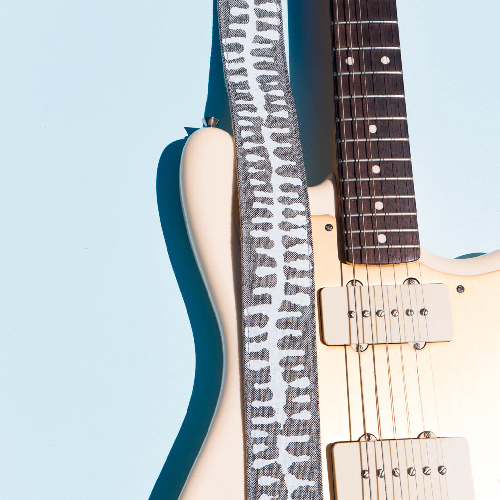 White and gray skeletal spine India block print vintage-style guitar strap by Original Fuzz.