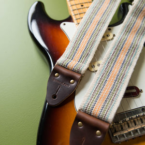Hand woven Peruvian guitar strap in cream with rainbow stripes hand made in Nashville by Original Fuzz. 