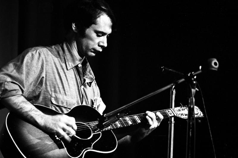 John Fahey finger picks his guitar