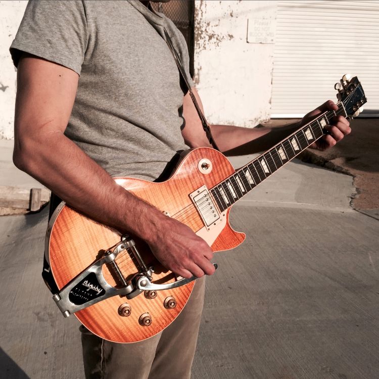 A Les Paul with a Bigsby and Original Fuzz strap