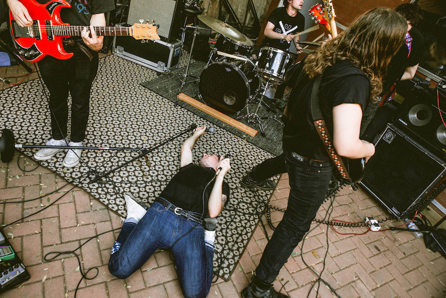 White reaper performs in a basement