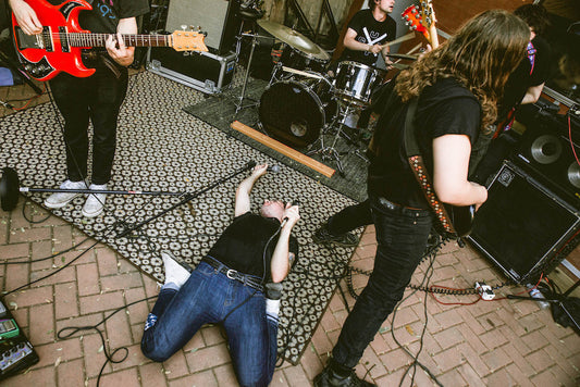 White reaper performs in a basement