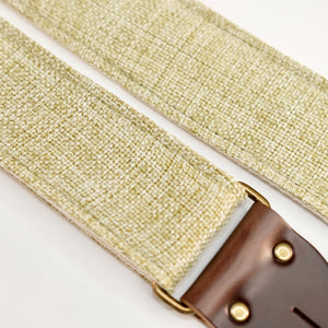 Fabric detail view of guitar strap in green and cream woven fabric with brown leather end-tab. Made in Nashville by Original Fuzz.