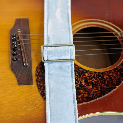 Buckle detail of guitar strap in pale silver blue velvet with black leather end-tab. Made in Nashville by Original Fuzz.