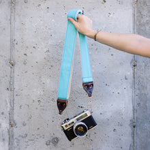 Light arctic blue vintage-style camera strap made by Original Fuzz in Nashville, TN. with a Yashica film camera.