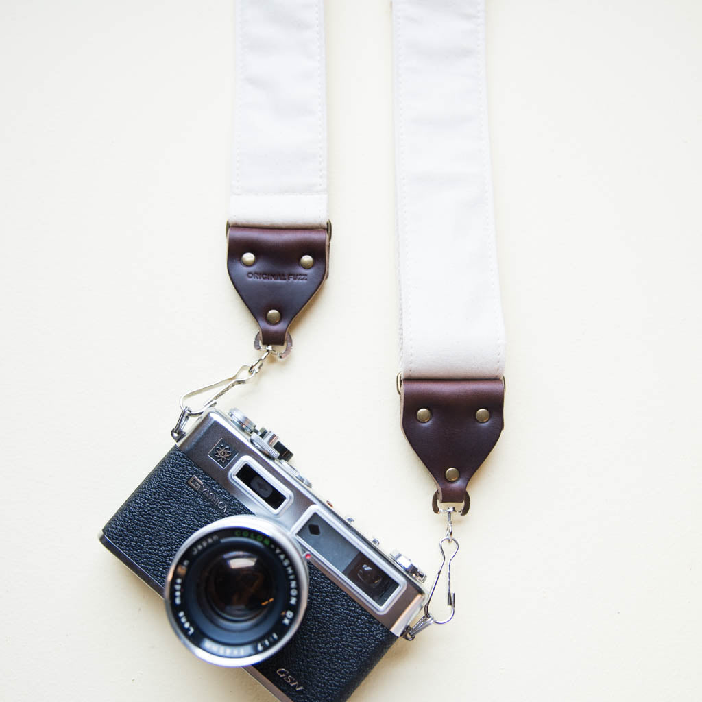 Cream white cotton canvas vintage-style camera strap made by Original Fuzz in Nashville, TN with Yashica film camera.