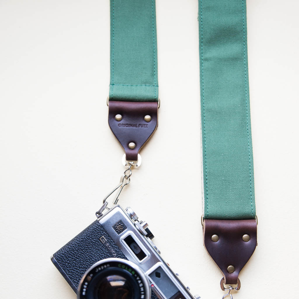 Green cotton canvas vintage-style camera strap with antique brass hardware by Original Fuzz.