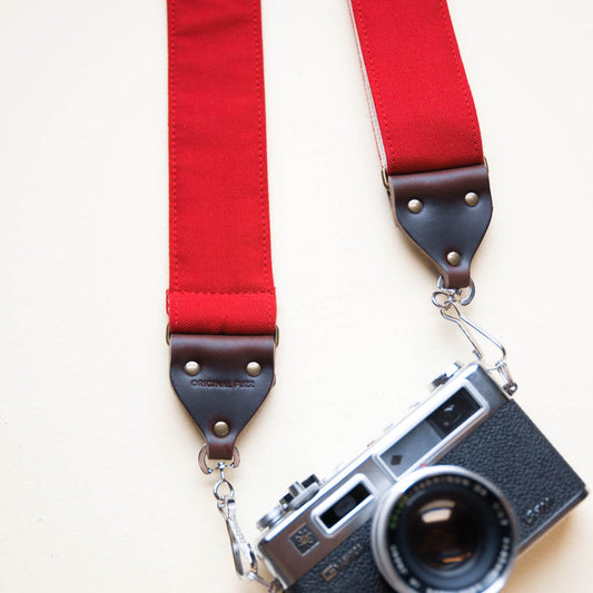 Red cotton canvas vintage-style camera strap made by Original Fuzz in Nashville with a Yashica film camera.