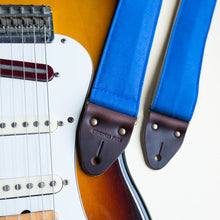 Blue vintage-style cotton canvas guitar strap made by Original Fuzz in Nashville with a Fender Jazzmaster.