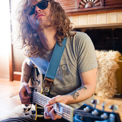 Blue vintage-style cotton canvas guitar strap with antique brass hardware made by Original Fuzz in Nashville.