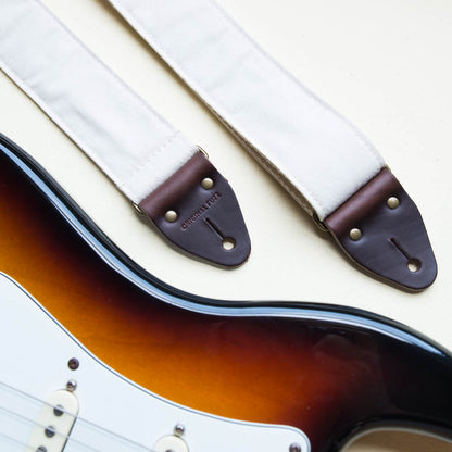 Cream white cotton canvas vintage-style guitar strap made by Original Fuzz in Nashville, TN with a Fender Jazzmaster.