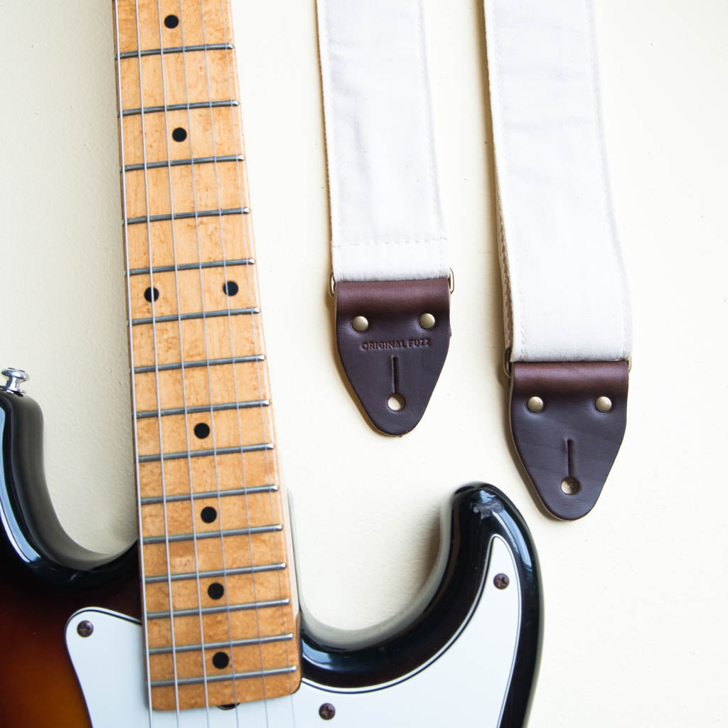 Cream white cotton canvas vintage-style guitar strap made by Original Fuzz in Nashville, TN with a Fender Jazzmaster.