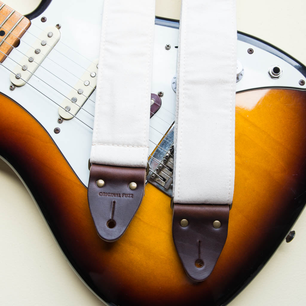 Cream white cotton canvas vintage-style guitar strap made by Original Fuzz in Nashville, TN with a Fender Jazzmaster.