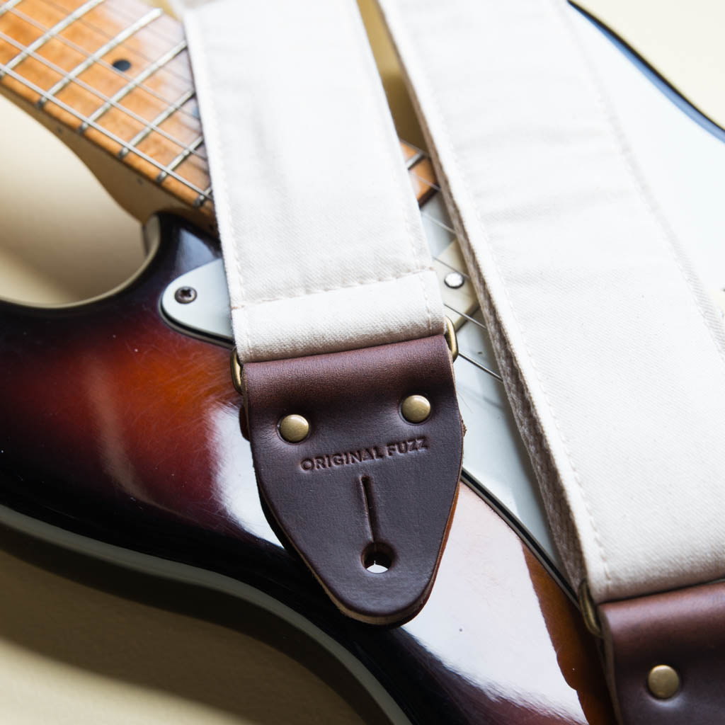 Cream white cotton canvas vintage-style guitar strap made by Original Fuzz in Nashville, TN with a Fender Jazzmaster.