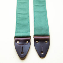 Green cotton canvas guitar strap with antique brass hardware and Horween leather made by Original Fuzz