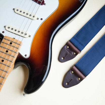 Navy blue cotton canvas guitar strap made by Original Fuzz with a Fender Jazzmaster.