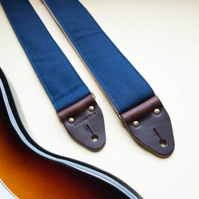 Navy blue cotton canvas guitar strap made by Original Fuzz with a Fender Jazzmaster.