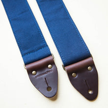 Navy blue cotton canvas vintage-style guitar strap made with Horween leather and antique brass hardware by Original Fuzz.