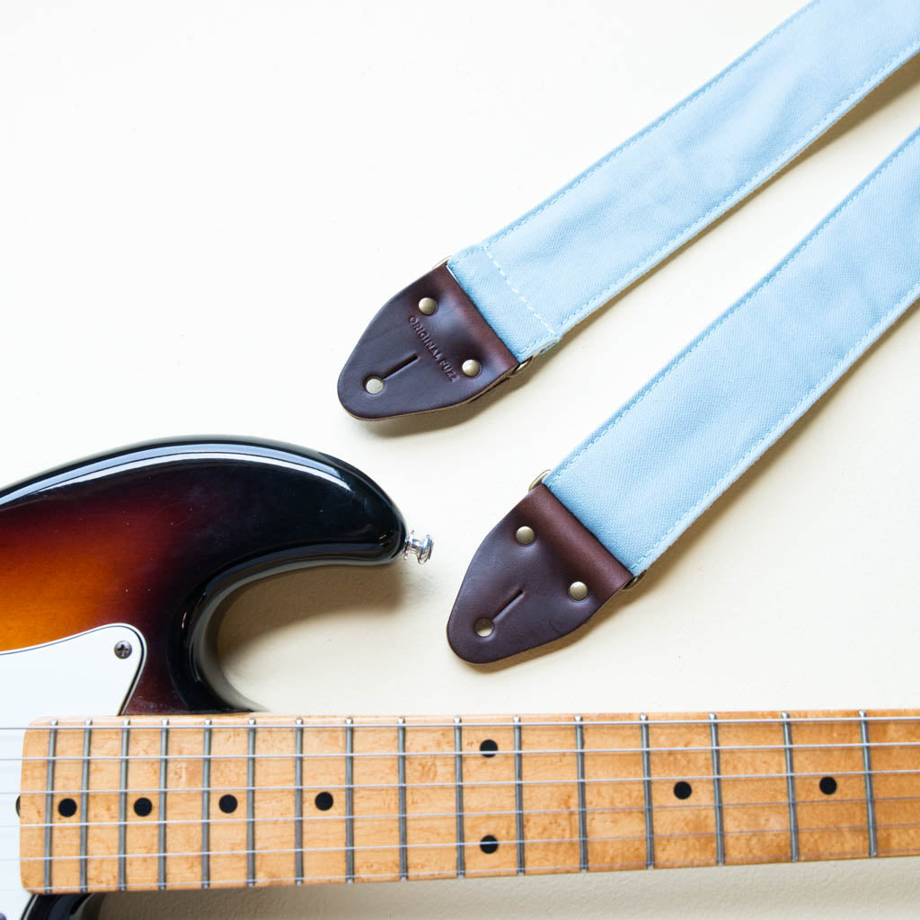 Light blue cotton canvas vintage-style guitar strap made by Original Fuzz in  Nashville, TN with a Fender Jazzmaster.