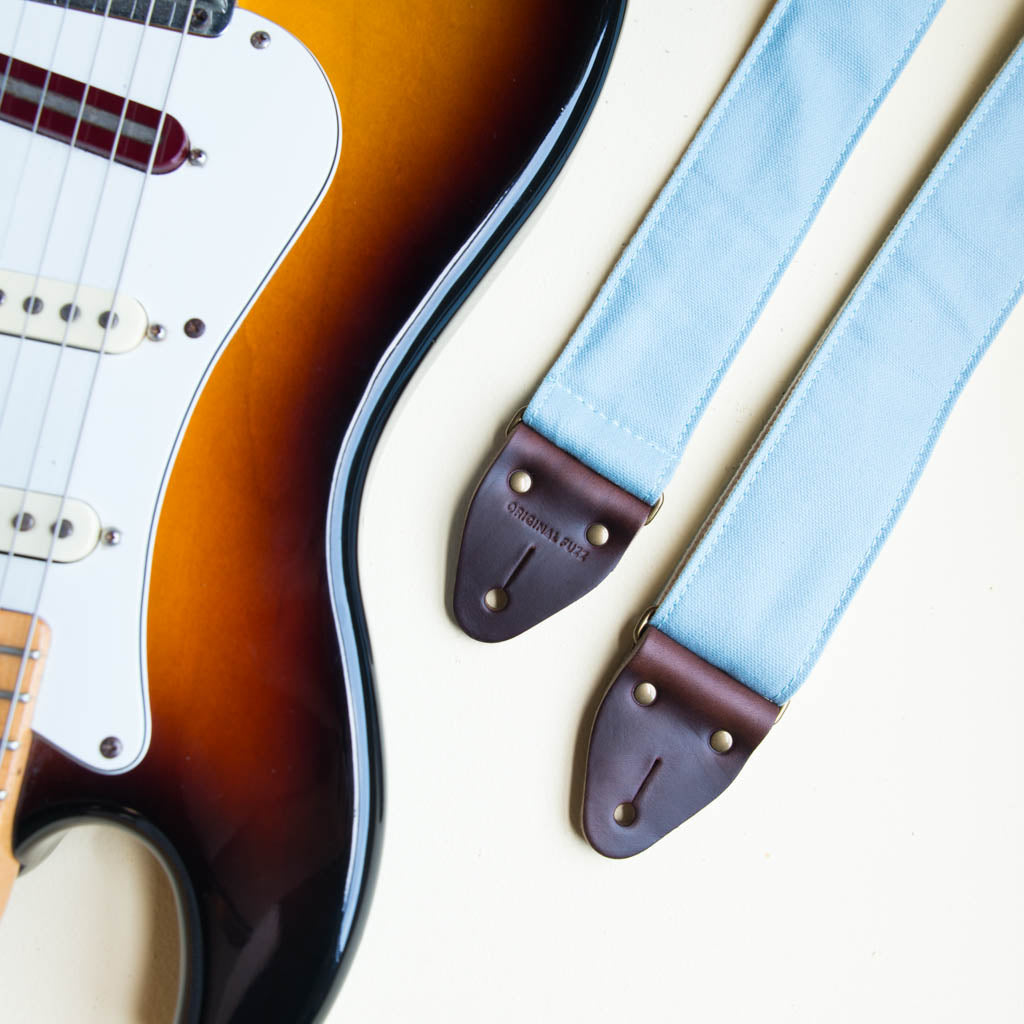 Light blue cotton canvas vintage-style guitar strap made by Original Fuzz in  Nashville, TN with a Fender Jazzmaster.