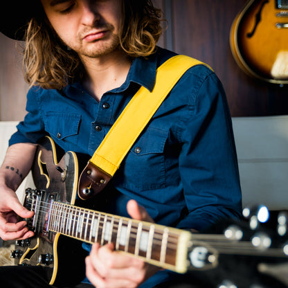 Yellow cotton canvas vintage-style guitar strap with antique brass hardware made by Original Fuzz in Nashville, TN.