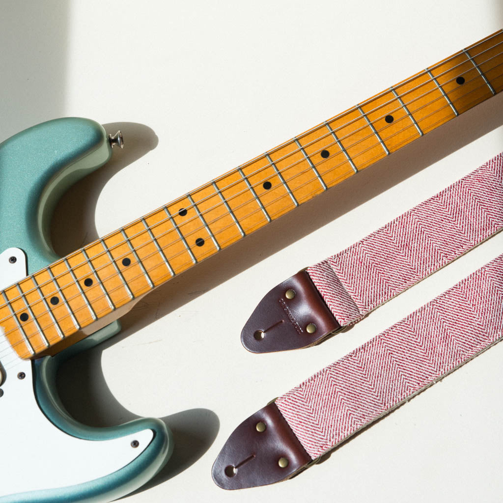 Red and cream herringbone woven cotton from India vintage-style guitar strap made by Original Fuzz with Fender Stratocaster.