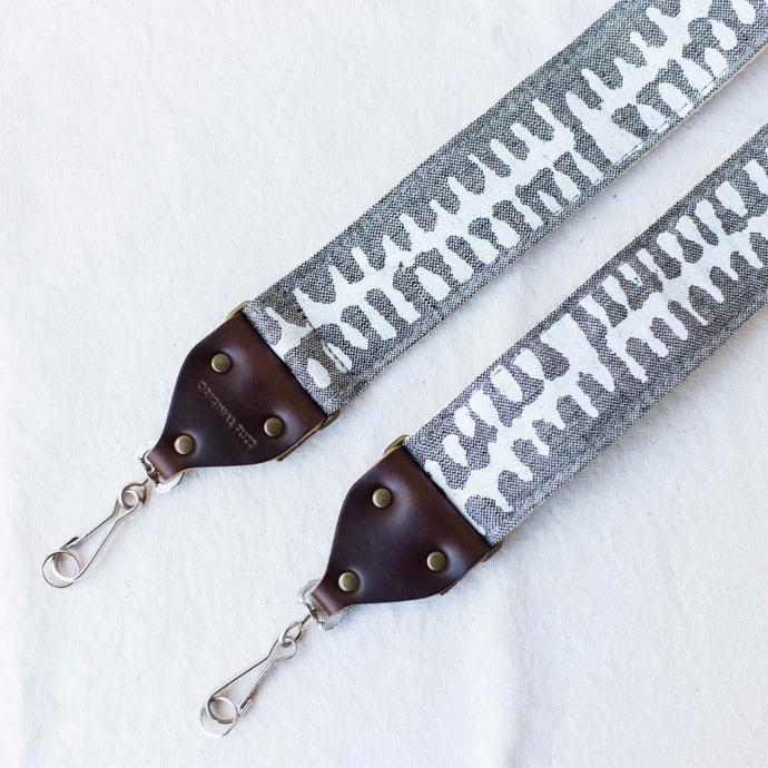 White and gray vintage-style camera strap made with fabric block printed in India by Original Fuzz in Nashville, TN. 