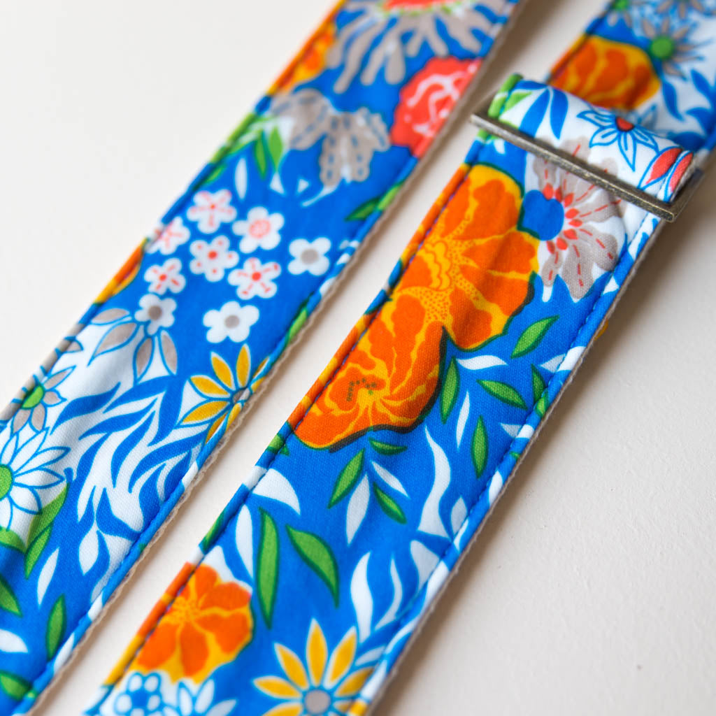 Vibrant blue floral guitar strap made with reclaimed vintage polyester by Original Fuzz. 