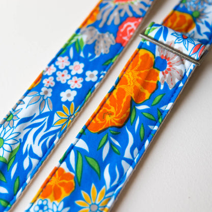 Vibrant blue floral guitar strap made with reclaimed vintage polyester by Original Fuzz. 