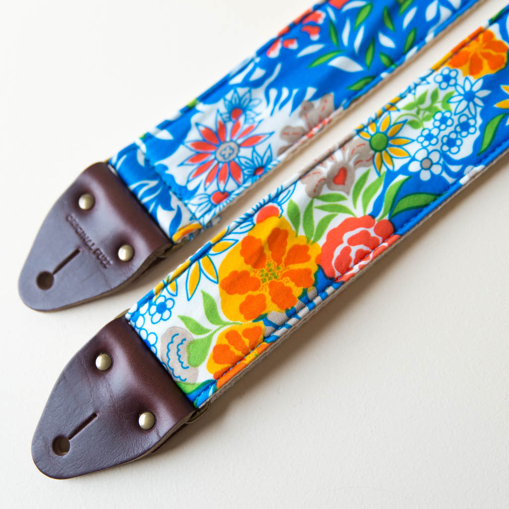 Vibrant blue floral guitar strap made with reclaimed vintage polyester by Original Fuzz. 