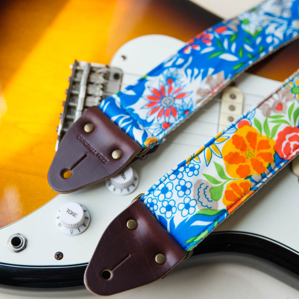 Vibrant blue floral guitar strap made with reclaimed vintage polyester by Original Fuzz. 