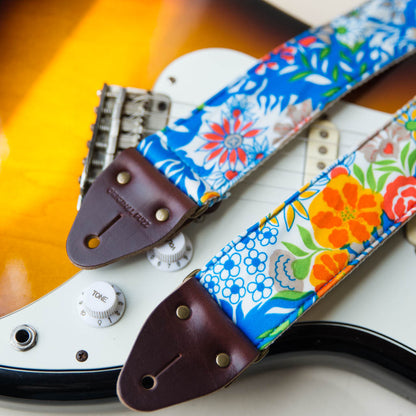 Vibrant blue floral guitar strap made with reclaimed vintage polyester by Original Fuzz. 