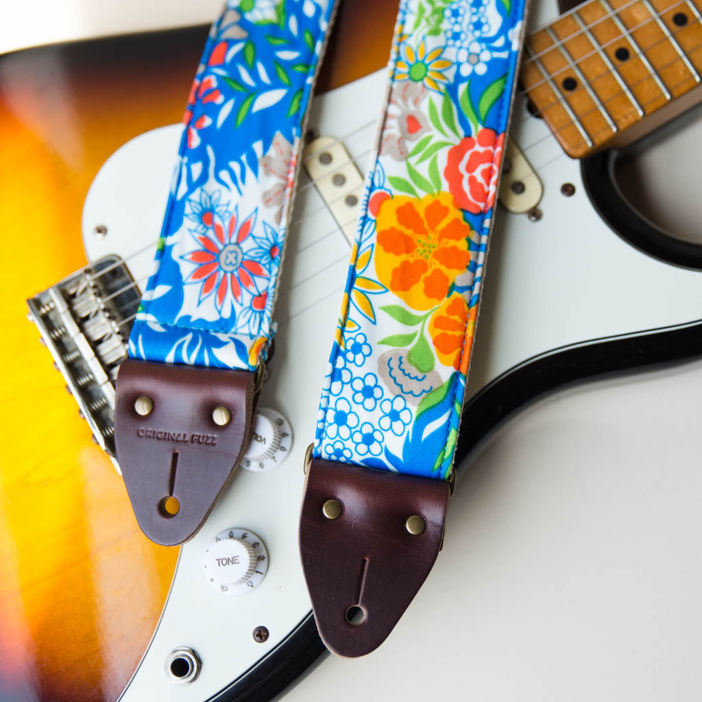 Vibrant blue floral guitar strap made with reclaimed vintage polyester by Original Fuzz. 