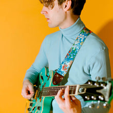 Vibrant blue floral guitar strap made with reclaimed vintage polyester by Original Fuzz. 