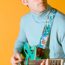 Vibrant blue floral guitar strap made with reclaimed vintage polyester by Original Fuzz. 