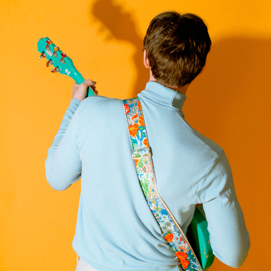 Vibrant blue floral guitar strap made with reclaimed vintage polyester by Original Fuzz. 