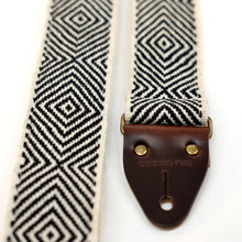 Closeup of horsemen leather and antique brass hardware on this Peruvian guitar strap