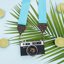Light arctic blue vintage-style camera strap made by Original Fuzz in Nashville, TN. with a Yashica film camera.