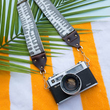 White and gray vintage-style camera strap made with fabric block printed in India by Original Fuzz in Nashville, TN. 