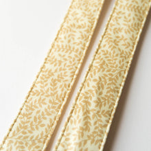 Vintage guitar strap made with repurposed yellow polyester with a repeating leaf design by Original Fuzz. 