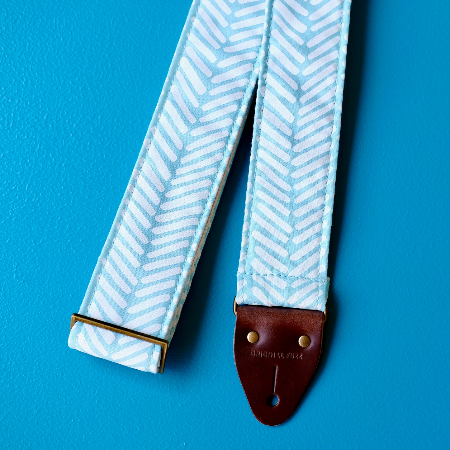 Light blue silkscreened guitar strap handmade in Nashville by Original Fuzz.