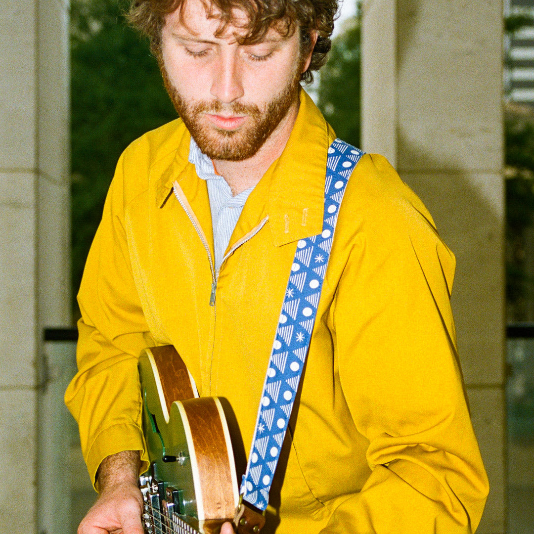 Real Estate's bassist Alex Bleeker designed this skinny guitar strap for Original Fuzz made with blue cotton and silkscreened by Grand Palace with white ink in Nashville, TN. 