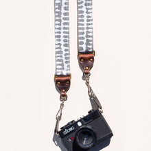 White and gray vintage-style skinny camera strap made with fabric block printed in India by Original Fuzz in Nashville, TN. 