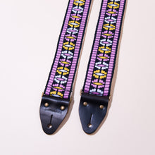 Pink is the predominant color in this vintage woven jacquard guitar strap