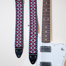 The vintage guitar strap in Patton Ave features black horween leather end tabs