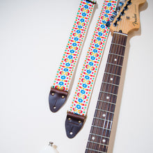 The Vintage Guitar Strap in Tabernacle Road next to a Fender headstock