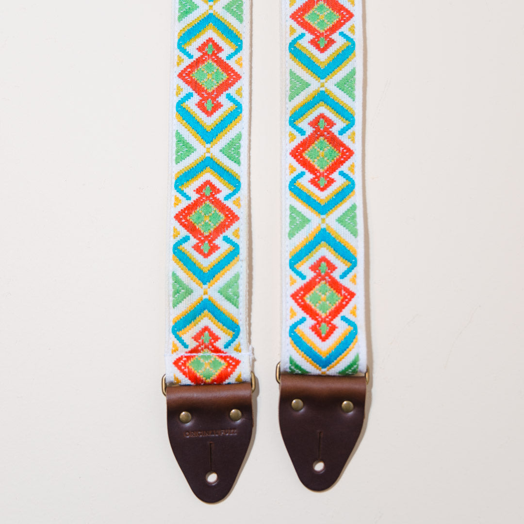 Close-up of the brown leather end tabs on the vintage guitar strap in Town Mountain Road